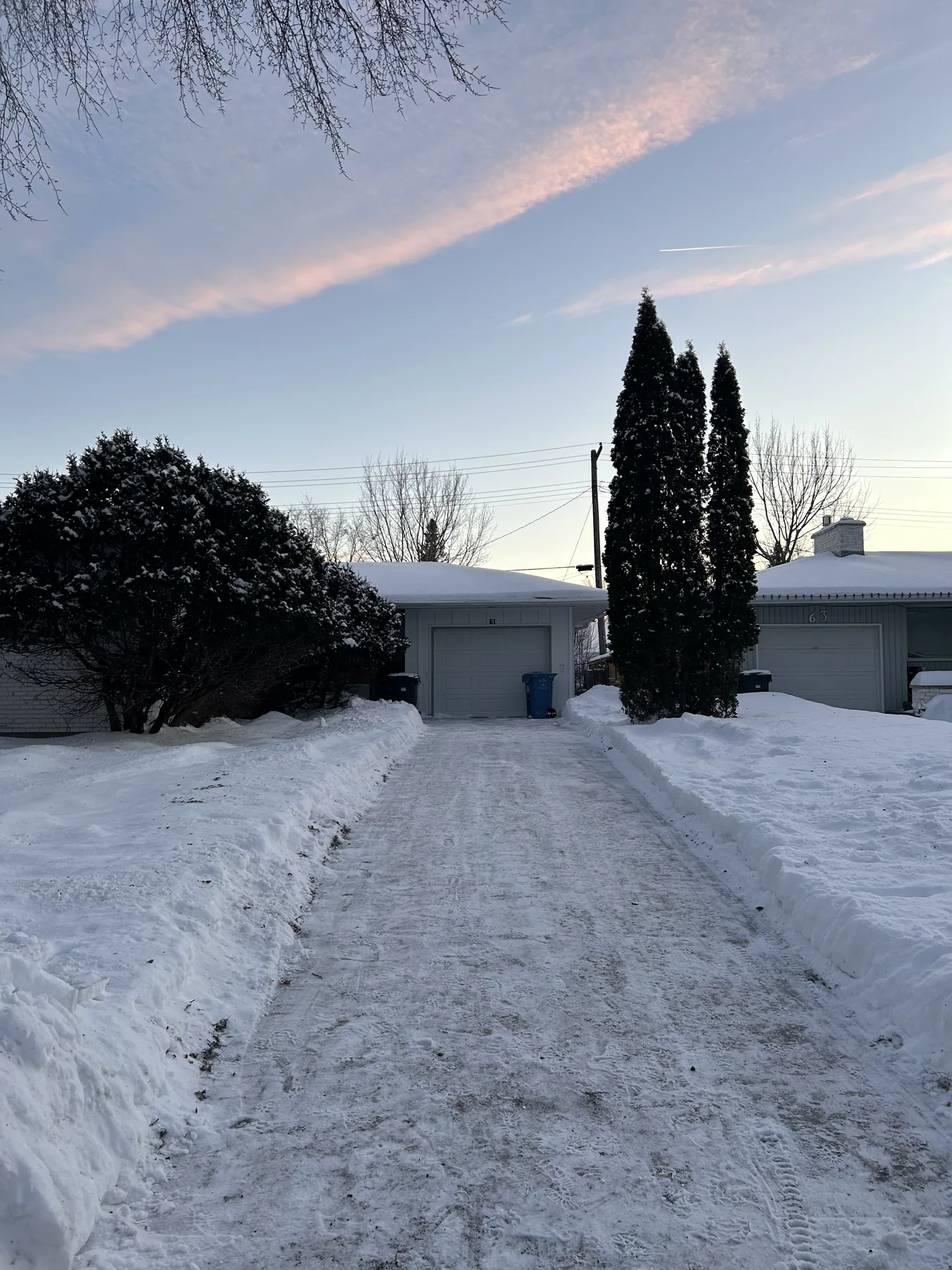 The same residential driveway cleared after snow removal service