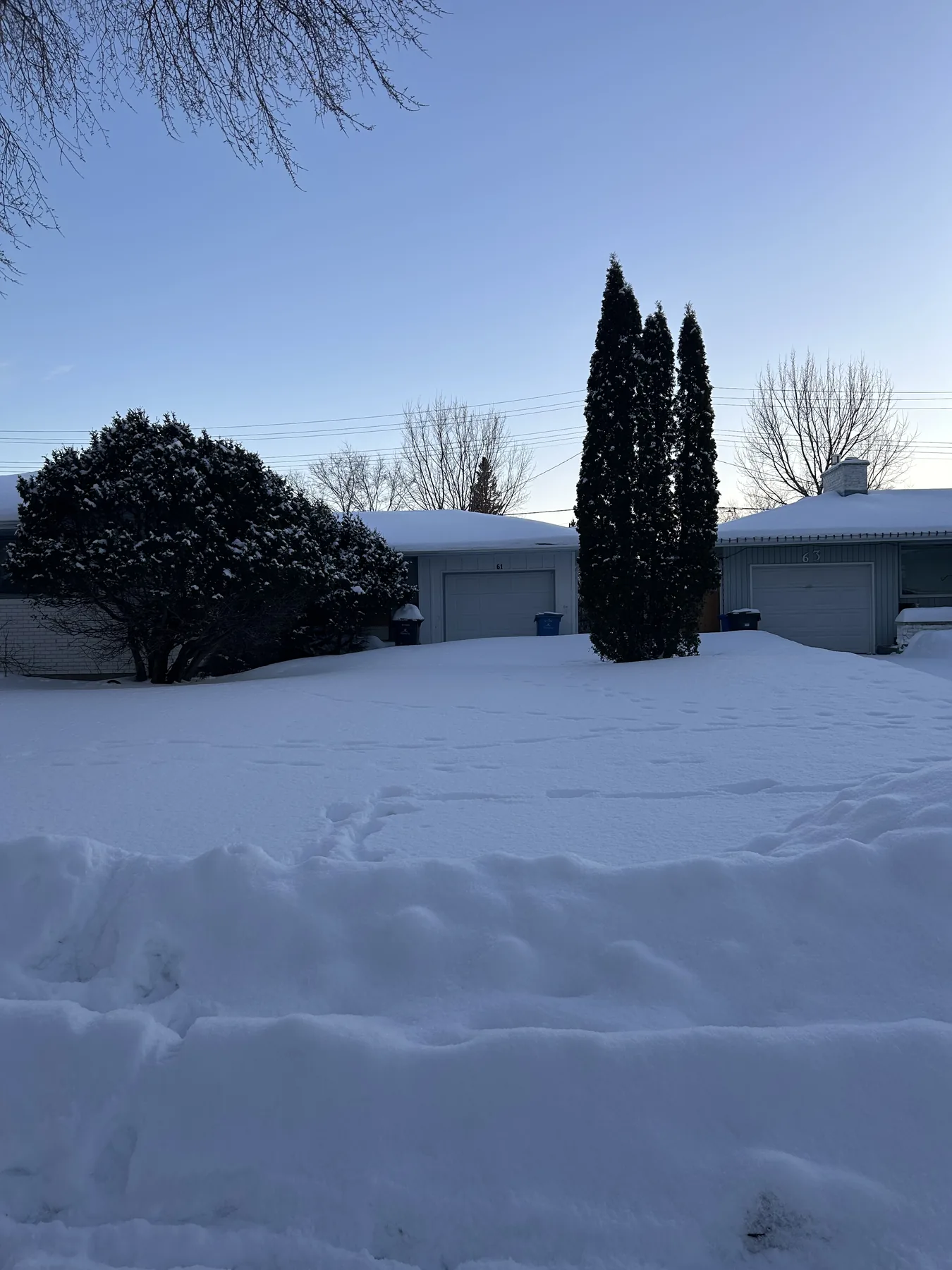 Snow-covered residential driveway before snow removal service