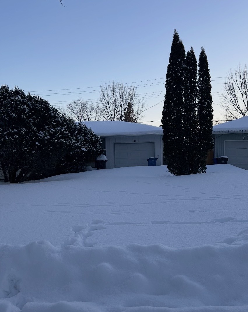 Residential driveway covered in deep snow before Keystone snow removal service